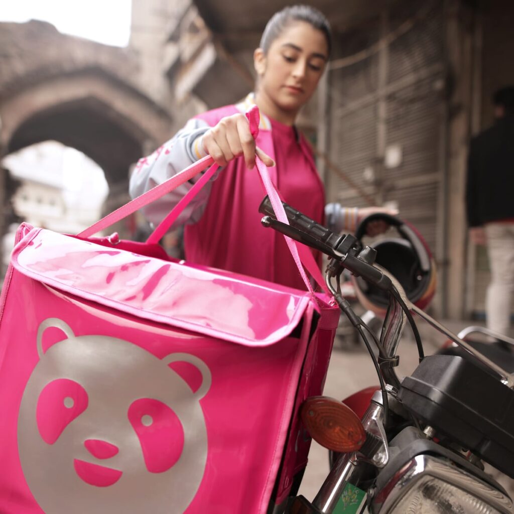 a girl is delivering food to customer